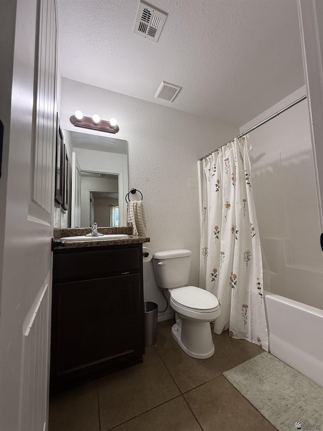 126 N Joe Harper Ct, San Luis, AZ 85349 - bathroom with toilet, tile patterned flooring, vanity, shower / tub combo with curtain, and a textured ceiling