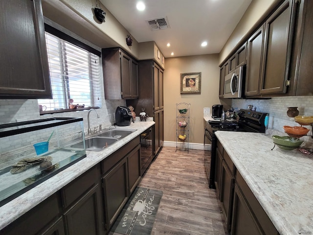 2193 S 40th Dr, Yuma, AZ 85364 - kitchen with black electric range oven, stainless steel microwave, decorative backsplash, light countertops, and recessed lighting