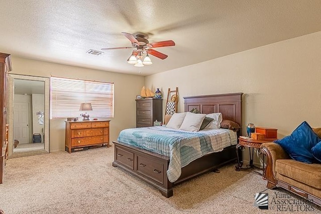 6324 E 45th Ln, Yuma, AZ 85365 - bedroom featuring light colored carpet, a textured ceiling, and ceiling fan
