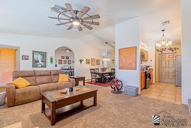 6324 E 45th Ln, Yuma, AZ 85365 - living room featuring a ceiling fan, light carpet, vaulted ceiling, a chandelier, and light tile patterned floors