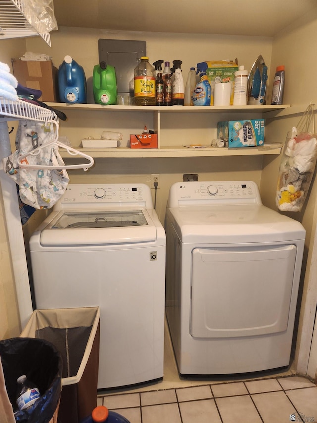 laundry area featuring independent washer and dryer, light tile patterned flooring, and laundry area
