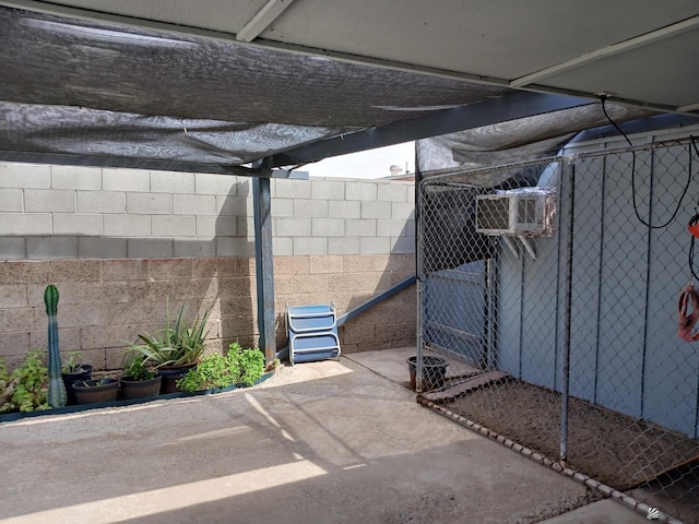 exterior space featuring concrete block wall