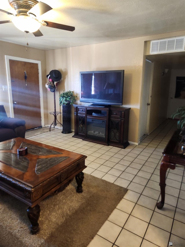 living area featuring visible vents, ceiling fan, and light tile patterned flooring