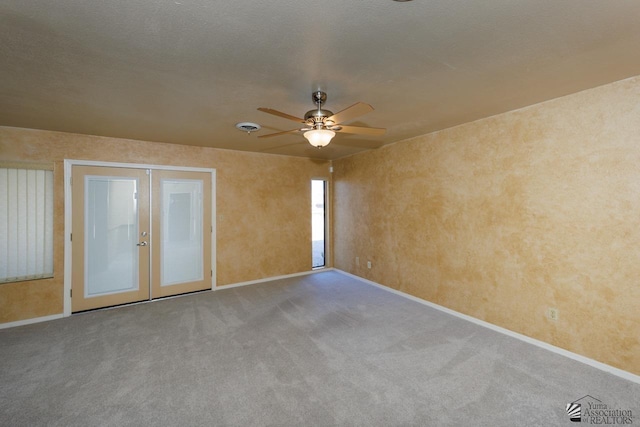 unfurnished room featuring french doors, light carpet, ceiling fan, and baseboards