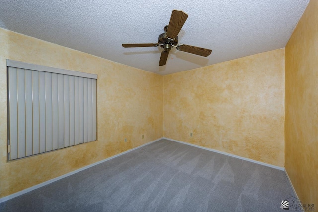 carpeted empty room with a textured ceiling and baseboards