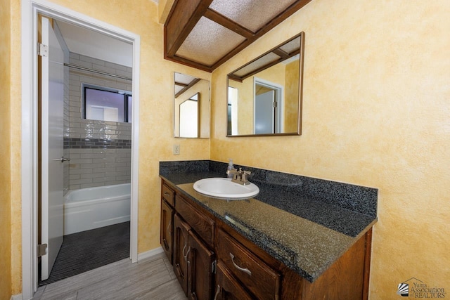 bathroom with shower / bathing tub combination and vanity