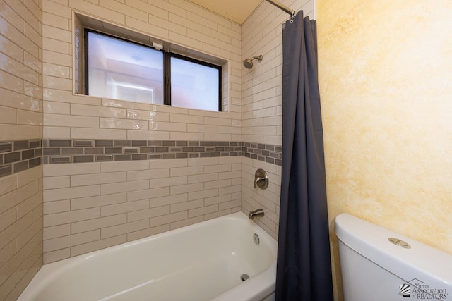 bathroom with shower / tub combo with curtain and toilet