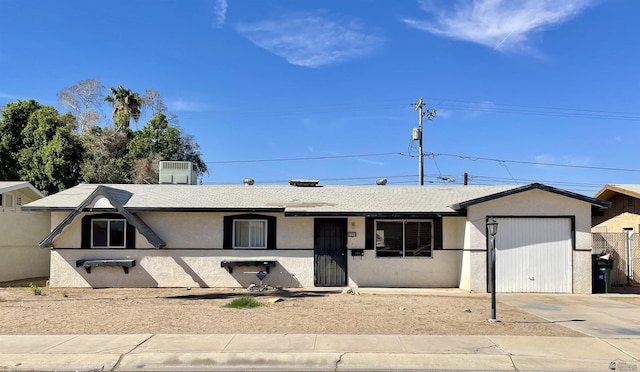 view of front of home with cooling unit and a garage