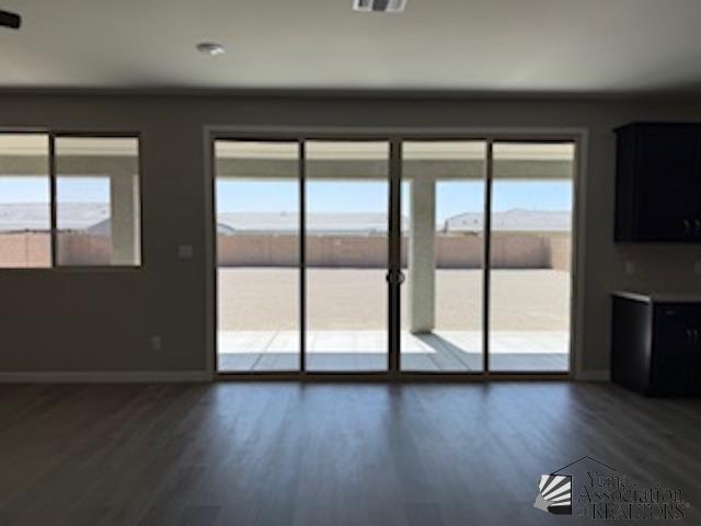 12380 S Grandview Dr, Yuma, AZ 85367 - unfurnished living room with dark wood-style floors and baseboards