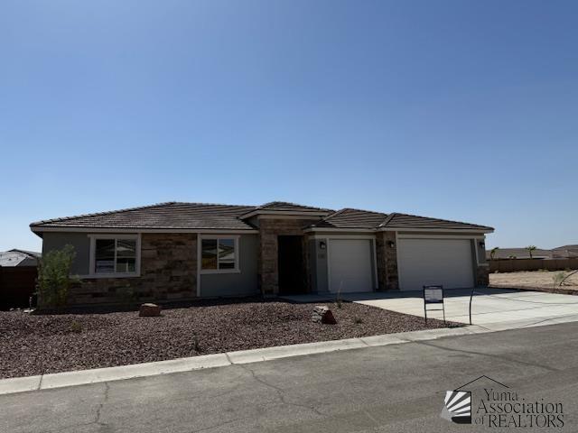 12380 S Grandview Dr, Yuma, AZ 85367 - prairie-style home featuring stone siding, concrete driveway, and an attached garage