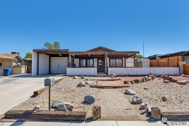 1344 W 13th St, Yuma, AZ 85364 - view of front of house with driveway, stucco siding, and an attached carport