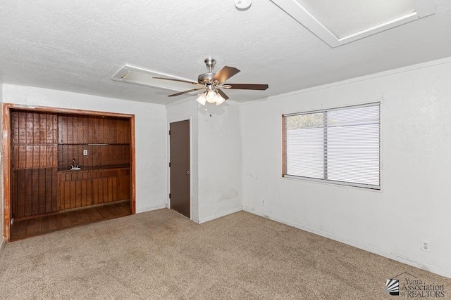 1344 W 13th St, Yuma, AZ 85364 - unfurnished bedroom featuring carpet floors, attic access, a ceiling fan, a textured ceiling, and baseboards
