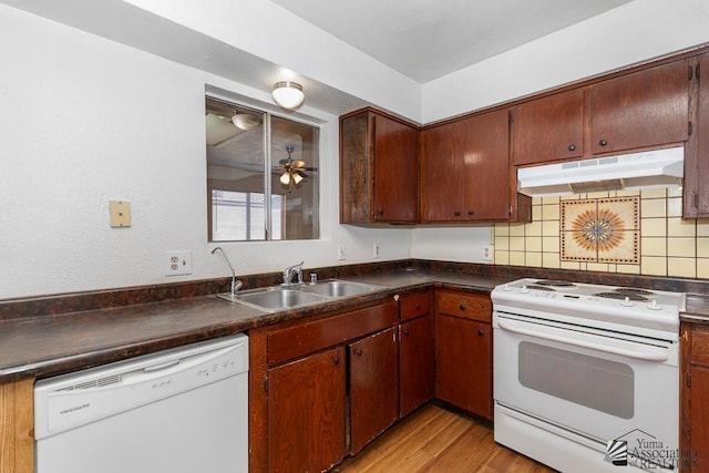 1344 W 13th St, Yuma, AZ 85364 - kitchen featuring white appliances, under cabinet range hood, a sink, and dark countertops