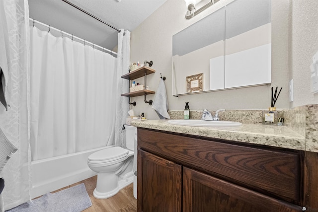 bathroom featuring vanity, wood finished floors, toilet, and shower / bath combo with shower curtain