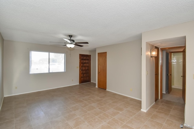 unfurnished room featuring ceiling fan and a textured ceiling