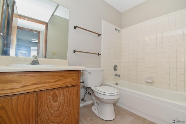 full bathroom with tile patterned flooring, vanity, tiled shower / bath combo, and toilet