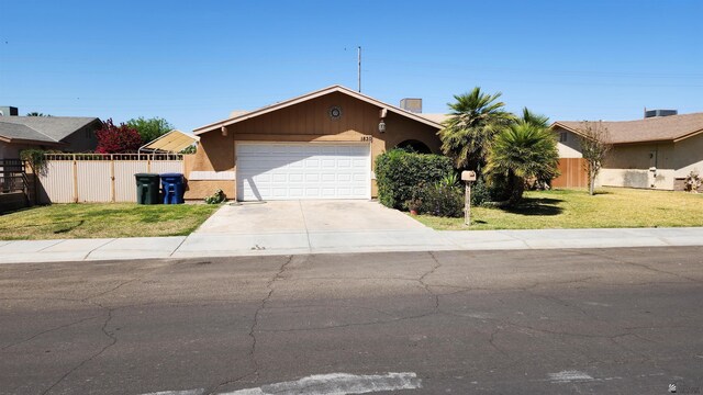 1830 S Athens Ave, Yuma, AZ 85364 - ranch-style home with fence, a garage, driveway, and a front lawn