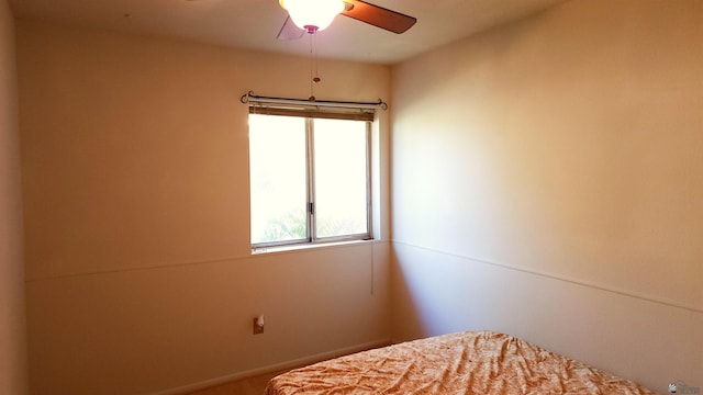 bedroom featuring multiple windows and ceiling fan