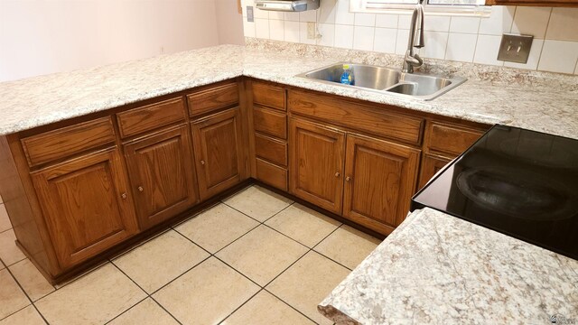 1830 S Athens Ave, Yuma, AZ 85364 - kitchen featuring brown cabinets, tasteful backsplash, a sink, and light countertops