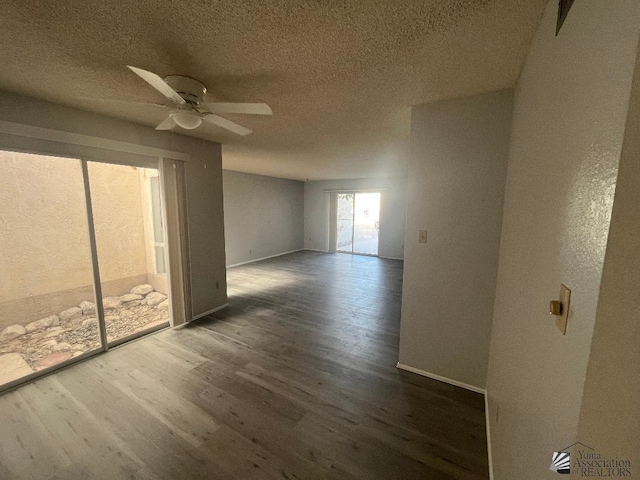 unfurnished room with dark hardwood / wood-style flooring, ceiling fan, and a textured ceiling