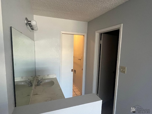 bathroom with vanity and a textured ceiling