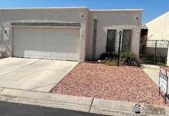 southwest-style home with a garage