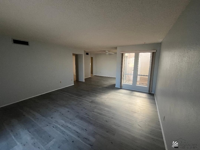 empty room with ceiling fan, hardwood / wood-style floors, and a textured ceiling