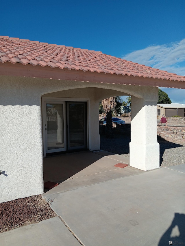 13835 E 51st Ln, Yuma, AZ 85367 - doorway to property featuring stucco siding, a patio area, and a tile roof