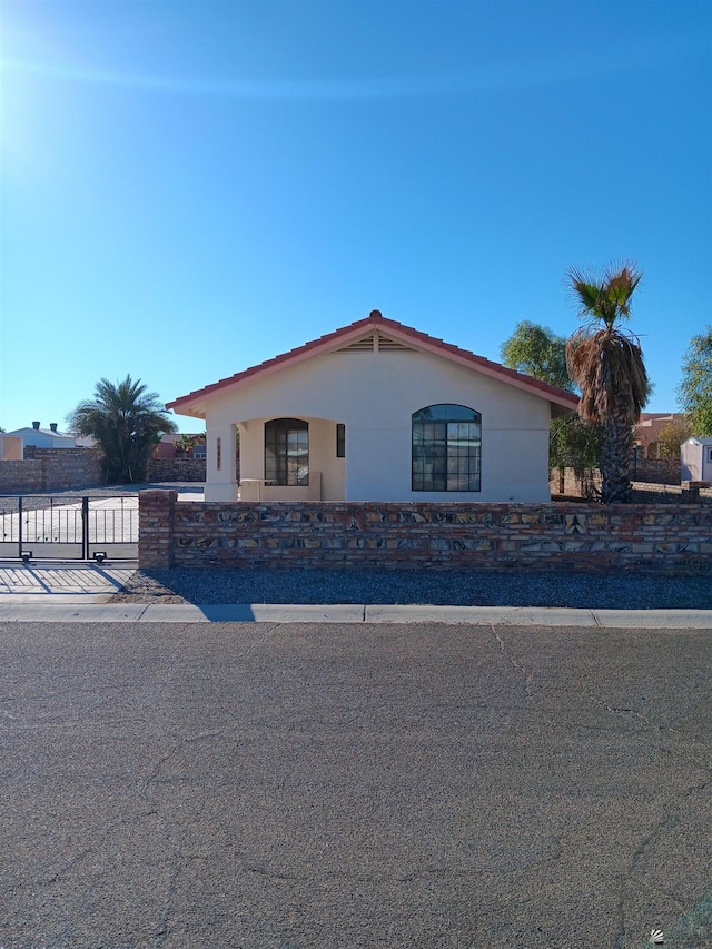 13835 E 51st Ln, Yuma, AZ 85367 - view of front of house with a gate, stucco siding, and fence private yard