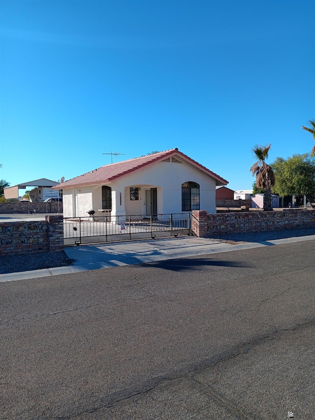 13835 E 51st Ln, Yuma, AZ 85367 - view of front of house with a gate, stucco siding, fence private yard, and a tile roof