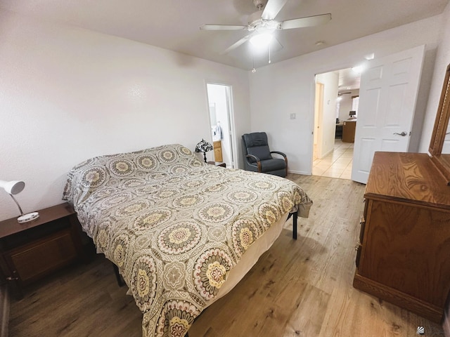 bedroom featuring ceiling fan, wood finished floors, and connected bathroom