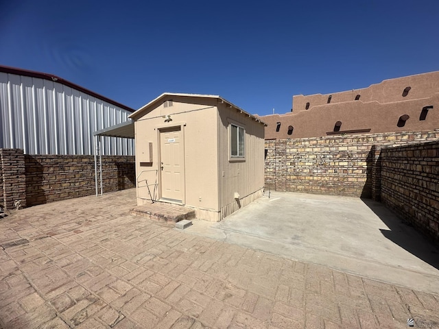 view of shed featuring fence