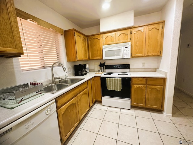 kitchen featuring a sink, light tile patterned flooring, white appliances, and light countertops