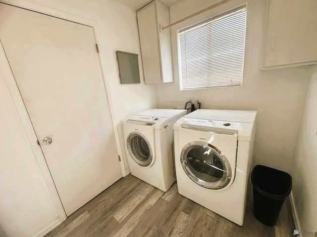 laundry room with light wood-style flooring and independent washer and dryer