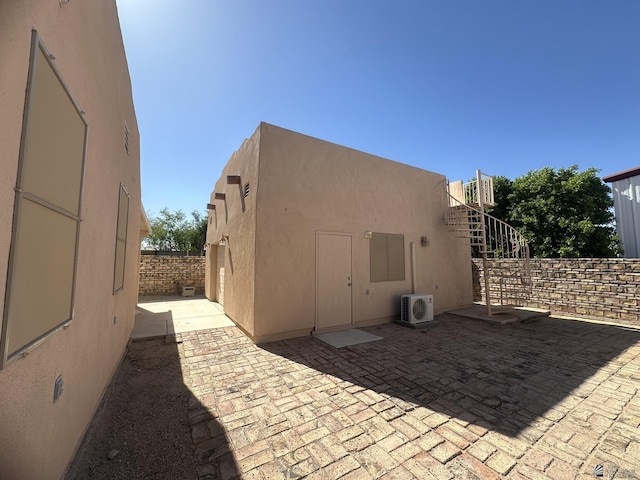 back of house with fence, ac unit, a patio area, and stucco siding