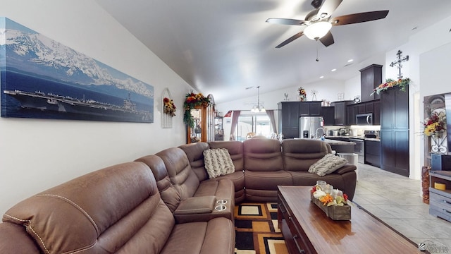 living room with a ceiling fan, lofted ceiling, and light tile patterned floors
