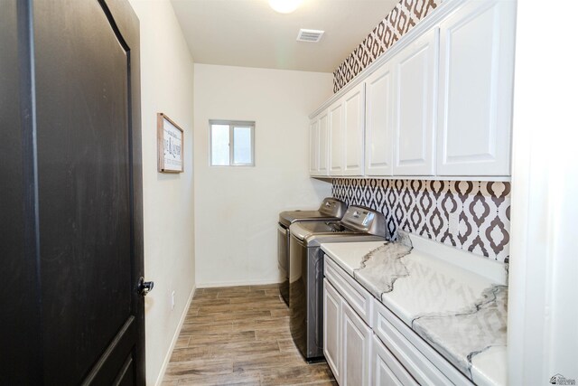 5712 E 45th Pl, Yuma, AZ 85365 - washroom featuring cabinet space, washing machine and dryer, light wood-style flooring, and baseboards