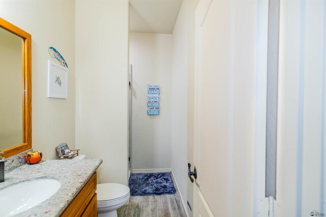 5712 E 45th Pl, Yuma, AZ 85365 - half bath with wood finished floors, vanity, toilet, and baseboards