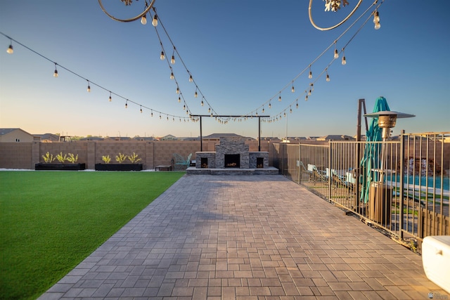 5712 E 45th Pl, Yuma, AZ 85365 - view of front of property with an outdoor fireplace, a patio, and a playground
