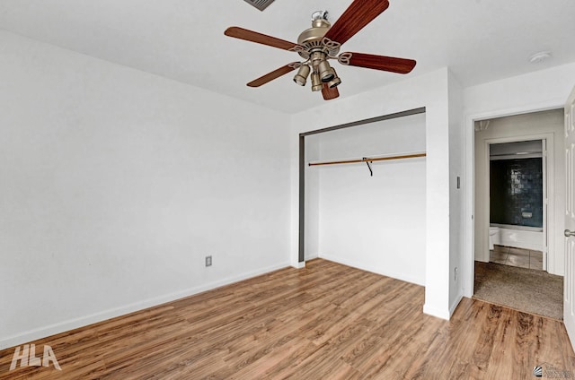 unfurnished bedroom with baseboards, ceiling fan, a closet, and wood finished floors