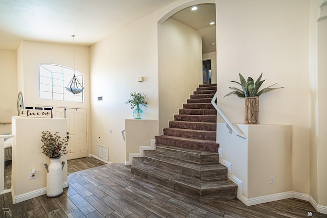 4031 W 16th Pl, Yuma, AZ 85364 - foyer featuring dark wood-type flooring, arched walkways, stairs, recessed lighting, and baseboards
