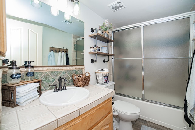 4031 W 16th Pl, Yuma, AZ 85364 - bathroom with vanity, toilet, and combined bath / shower with glass door