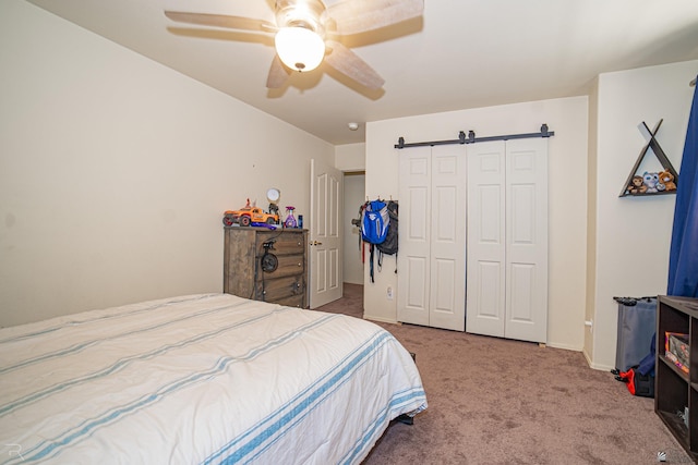 4031 W 16th Pl, Yuma, AZ 85364 - carpeted bedroom with a barn door, a closet, ceiling fan, and baseboards