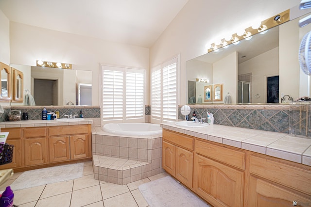 4031 W 16th Pl, Yuma, AZ 85364 - full bathroom with vaulted ceiling, tile patterned floors, a bath, vanity, and an enclosed shower