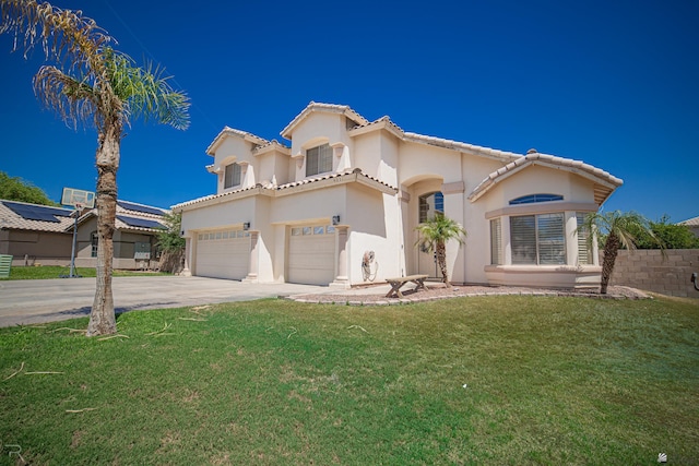 4031 W 16th Pl, Yuma, AZ 85364 - mediterranean / spanish home with a garage, driveway, a tiled roof, stucco siding, and a front lawn