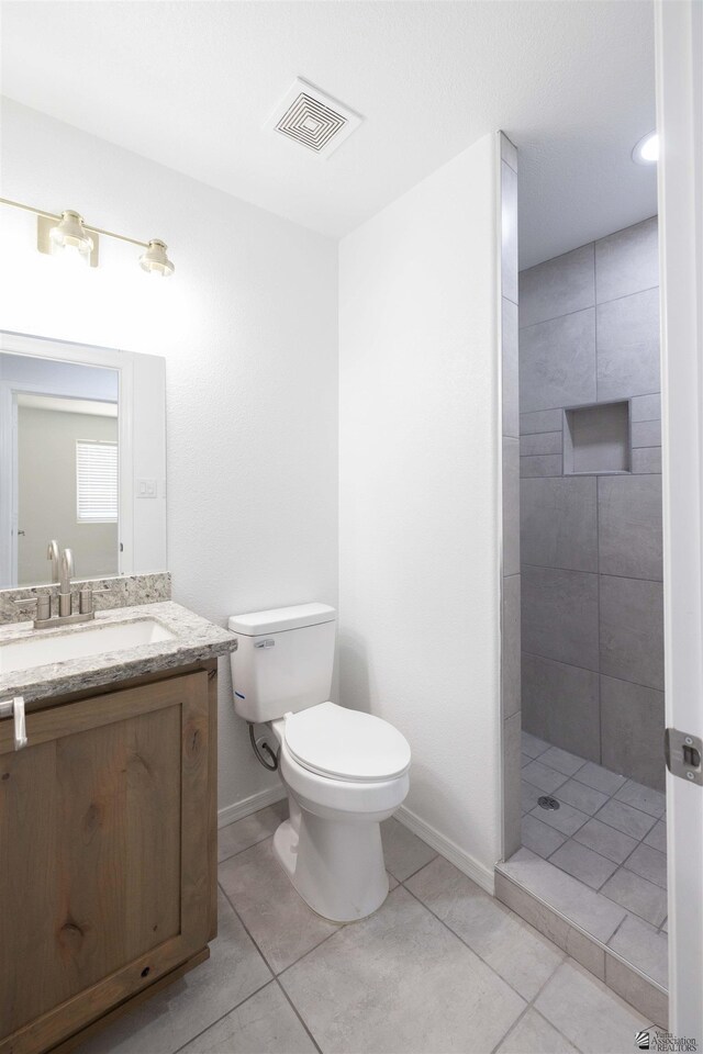 376 N 22nd Dr, San Luis, AZ 85336 - full bath featuring visible vents, tile patterned flooring, vanity, toilet, and tiled shower