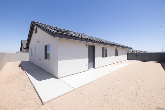 376 N 22nd Dr, San Luis, AZ 85336 - view of property exterior with a tiled roof, a fenced backyard, a patio area, and stucco siding