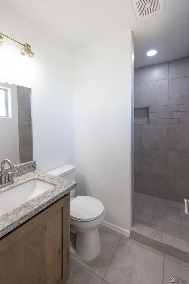 376 N 22nd Dr, San Luis, AZ 85336 - bathroom with visible vents, vanity, tile patterned floors, toilet, and tiled shower