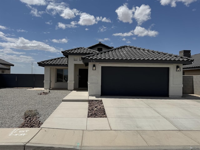 376 N 22nd Dr, San Luis, AZ 85336 - view of front of house with fence, stucco siding, concrete driveway, an attached garage, and a tile roof