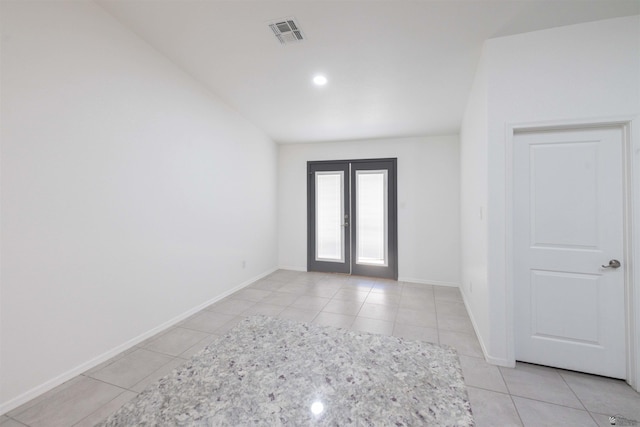 376 N 22nd Dr, San Luis, AZ 85336 - spare room with baseboards, light tile patterned floors, visible vents, and french doors